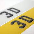 Load image into Gallery viewer, Close-up of '3D gel number plate text on a yellow and white background
