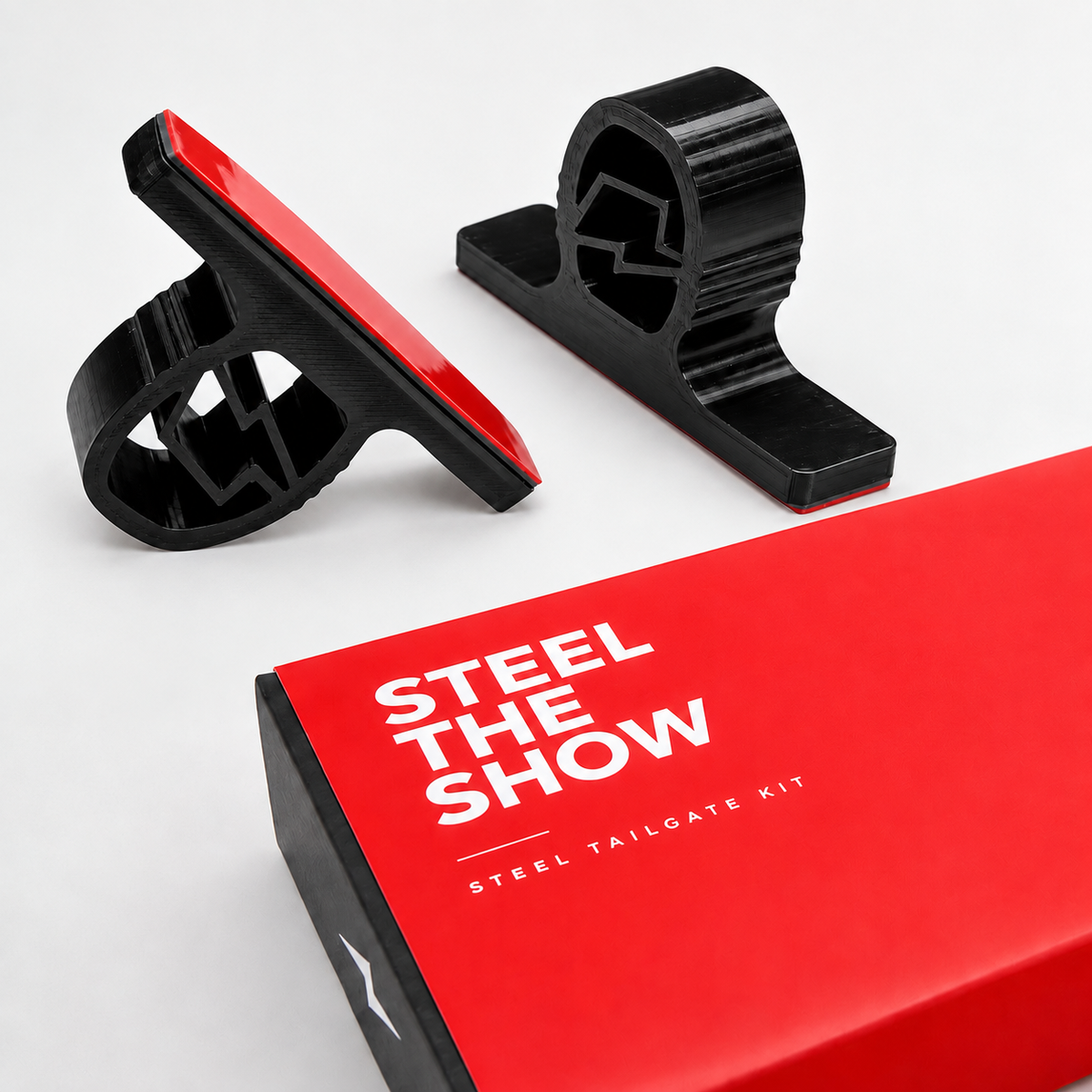 Steel the Show Tailgate Kit magnetic number plate kit for steel plate locations and the honey comb kit in a duo pack. One with a red backing, shown next to a red product box with white text on a light grey background.