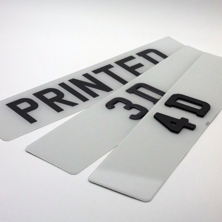 Three clear plastic car number plates with black text on a white background